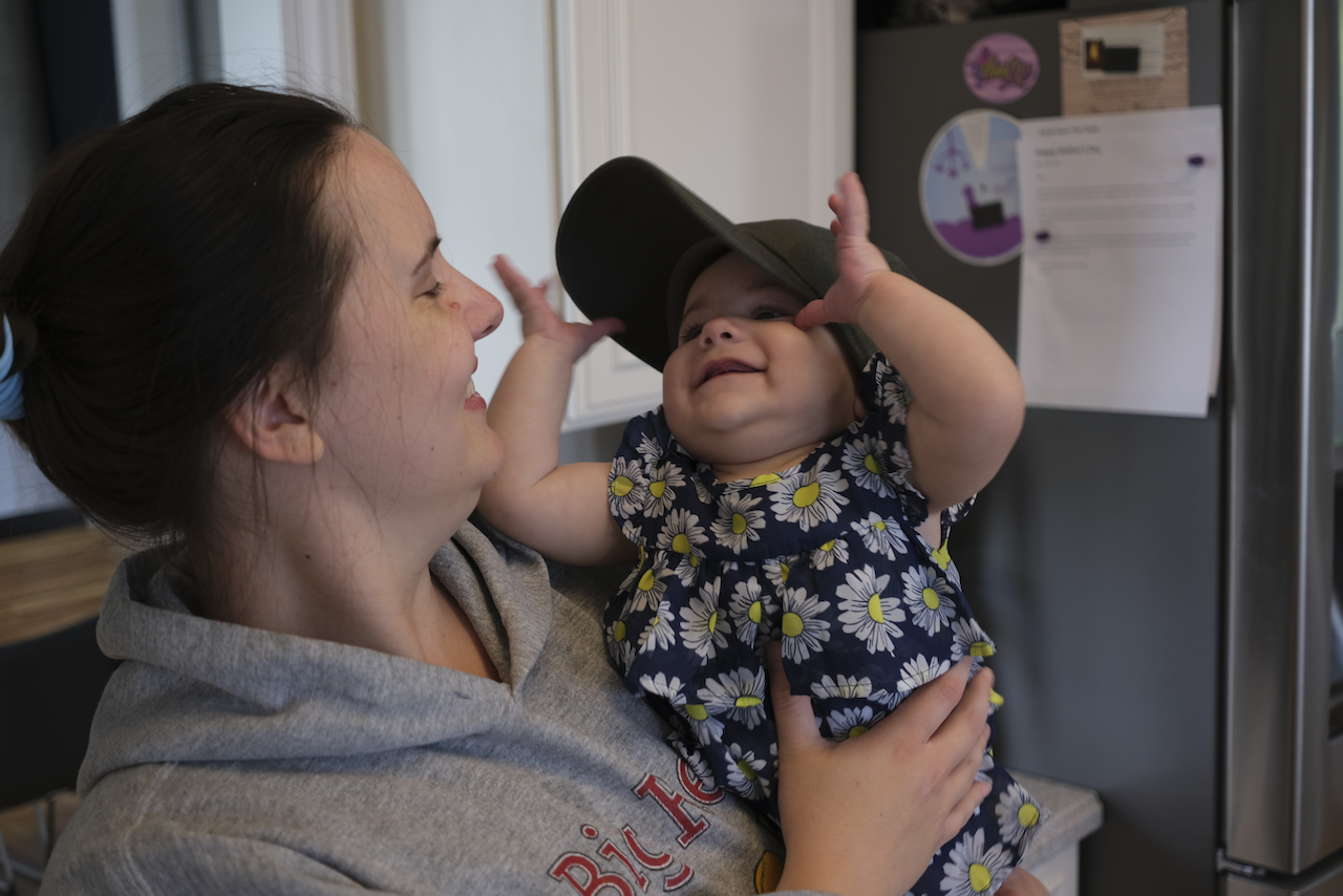 Zoe wearing a baseball cap that is far too big.